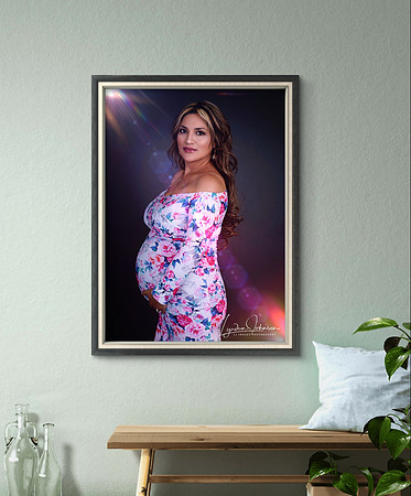 framed portrait of pregnant woman in flowery dress, having on wall