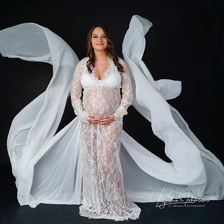 pregnancy portrait in studio on a black background, shit dress with tails, tails flying