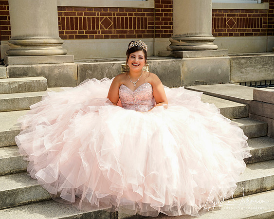 quinceañera portrait  of girl in pink dress sitting steps