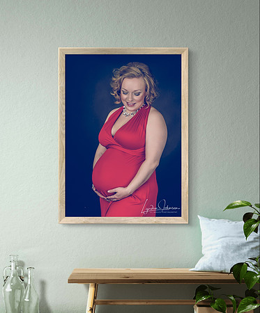 pregnant woman iin red dress, portrait on dark background, caucasian
