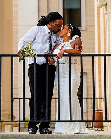 wedding portrait of bride and groom on second floor balcony by fence looking  at each other